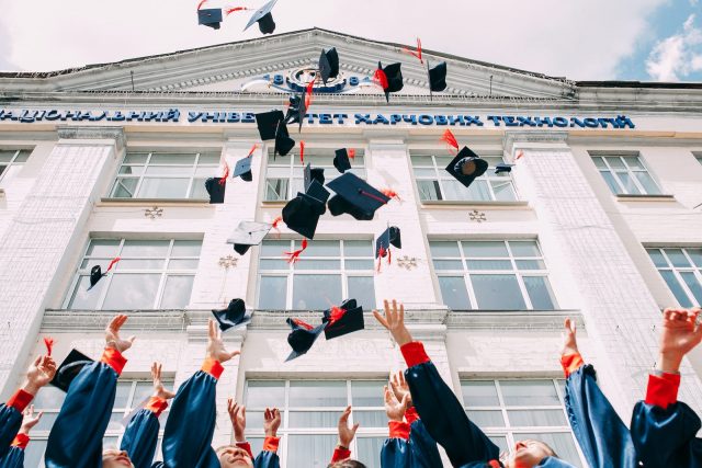 group of fresh graduates students throwing their academic hat in the air A College Degree