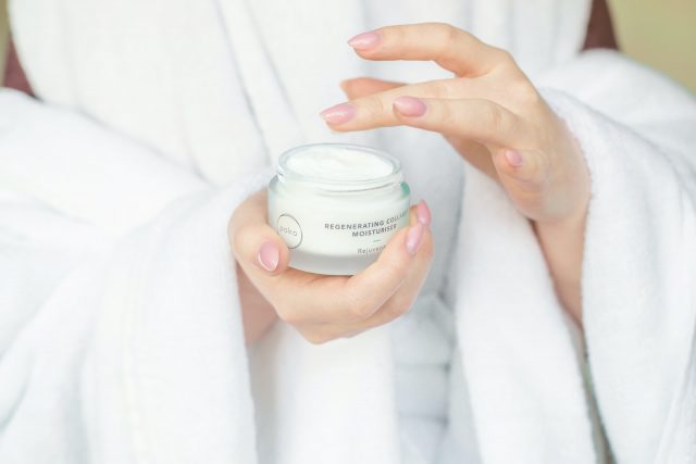 person holding white plastic container Antioxidant Antiaging
